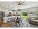 Open-concept living area with kitchen island, dining table, and living room with natural light at 114 Forest Meadow Ct, Garner, NC 27529