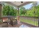 Inviting back porch with wooded views, perfect for relaxation and outdoor living at 1154 Yorkshire Dr, Burlington, NC 27215