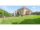 Beautifully manicured backyard with lush green grass, patio area, and privacy fence at 1154 Yorkshire Dr, Burlington, NC 27215