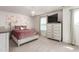 Bedroom featuring a crystal chandelier, plush pink bedding, decorative art, and multiple windows at 1154 Yorkshire Dr, Burlington, NC 27215