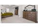 Well-lit bedroom with dresser, mirror, and ensuite access at 1154 Yorkshire Dr, Burlington, NC 27215