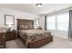 Bedroom with neutral carpet, a dark wood bed, and two windows dressed with black and white curtains at 1154 Yorkshire Dr, Burlington, NC 27215