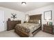 Primary bedroom featuring a wood bed, dresser, and white walls with hunting themed decor and two bedside tables at 1154 Yorkshire Dr, Burlington, NC 27215