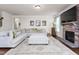 Comfortable living room featuring a stone fireplace, large sofa, and stylish rug at 1154 Yorkshire Dr, Burlington, NC 27215