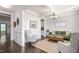 Bright living room boasts elegant trim work, hardwood floors, and comfortable seating at 1154 Yorkshire Dr, Burlington, NC 27215