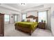 Spacious main bedroom with large bed, tray ceiling, dual windows, and ensuite access at 1154 Yorkshire Dr, Burlington, NC 27215