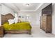 Bright main bedroom featuring a large bed, tray ceiling and ensuite bathroom at 1154 Yorkshire Dr, Burlington, NC 27215