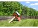 Backyard with playset and trampoline, great for to stay active and entertained outdoors at 1154 Yorkshire Dr, Burlington, NC 27215