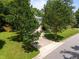 Aerial view of a home with a long driveway, manicured lawn, mature trees, and a cul-de-sac at 116 Lost Tree Ln, Cary, NC 27513
