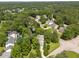 An aerial perspective of the home displays a swimming pool amidst lush greenery in a tranquil residential community at 116 Lost Tree Ln, Cary, NC 27513