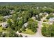 Aerial view showing the house nestled among lush trees, located on a serene street within a quiet, green neighborhood at 116 Lost Tree Ln, Cary, NC 27513