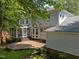 Lovely backyard featuring a brick patio, a screened-in porch, and mature trees creating a private outdoor space at 116 Lost Tree Ln, Cary, NC 27513