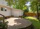 A spacious brick patio connects the house to an additional storage building providing an inviting area for outdoor activities at 116 Lost Tree Ln, Cary, NC 27513