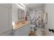 Bathroom with a neutral sink and vanity, matching nautical themed shower curtain and seashell accents at 116 Lost Tree Ln, Cary, NC 27513