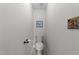Neutral powder room featuring a toilet with framed artwork at 116 Lost Tree Ln, Cary, NC 27513
