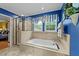 Bright bath features a tiled shower, a soaking tub, and windows with natural light at 116 Lost Tree Ln, Cary, NC 27513