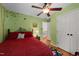 Bedroom featuring a ceiling fan and a painted tree mural with an ensuite at 116 Lost Tree Ln, Cary, NC 27513