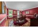 Dining room featuring an oval table, chandelier, and red walls at 116 Lost Tree Ln, Cary, NC 27513