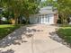 Long driveway to a two-story house with a light colored garage door at 116 Lost Tree Ln, Cary, NC 27513