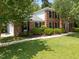Charming two-story brick home with well-manicured front lawn and mature landscaping at 116 Lost Tree Ln, Cary, NC 27513