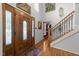 Grand foyer featuring a wood door, staircase, and beautiful hardwood floors at 116 Lost Tree Ln, Cary, NC 27513