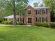 Charming two-story brick home with manicured lawn and mature landscaping at 116 Lost Tree Ln, Cary, NC 27513