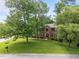 Beautiful brick home with well manicured lawn and landscaping, and mature trees providing shade at 116 Lost Tree Ln, Cary, NC 27513
