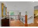 Hallway boasts gleaming hardwood floors, elegant stairway, and refined architectural details at 116 Lost Tree Ln, Cary, NC 27513