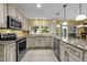 Bright and spacious kitchen with modern appliances, granite countertops, and tile flooring at 116 Lost Tree Ln, Cary, NC 27513