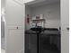 Convenient laundry room featuring a washer and dryer, complemented by storage shelves at 116 Lost Tree Ln, Cary, NC 27513