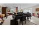 Elegant living room featuring a grand piano, chandelier, and large windows at 116 Lost Tree Ln, Cary, NC 27513