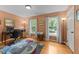 Home office with computer desk, hardwood floors, light orange walls, and large bright windows at 116 Lost Tree Ln, Cary, NC 27513