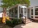 Charming screened porch with stairs, lattice details, and a view of the landscaped backyard, offering a relaxing outdoor space at 116 Lost Tree Ln, Cary, NC 27513