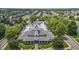 Aerial view of the clubhouse with community pool, playground, and surrounding mature trees at 1172 Pemberly Ave, Morrisville, NC 27560