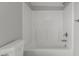 Bathroom features a white tiled tub and shower combination with gray walls and chrome fixtures at 1172 Pemberly Ave, Morrisville, NC 27560