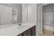 Bathroom with dark cabinets and a white sink, featuring a view to the shower and toilet at 1172 Pemberly Ave, Morrisville, NC 27560
