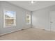 A serene bedroom with neutral carpet, gray walls, two large windows, and a door at 1172 Pemberly Ave, Morrisville, NC 27560