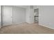 Neutral bedroom with carpeted floors, light gray walls, and paneled doors open to the hallway with stairs at 1172 Pemberly Ave, Morrisville, NC 27560