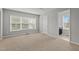 Neutral bedroom with carpeted floors, light gray walls, a double window and paneled doors open to the bathroom at 1172 Pemberly Ave, Morrisville, NC 27560