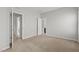 Carpeted bedroom with grey walls featuring a peek into an attached bathroom at 1172 Pemberly Ave, Morrisville, NC 27560