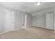 Neutral bedroom with carpeted floors, light gray walls, paneled doors open to the hallway and bathroom at 1172 Pemberly Ave, Morrisville, NC 27560