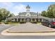 Traditional-style clubhouse boasts a clock tower, covered porch, manicured landscaping, and ample parking at 1172 Pemberly Ave, Morrisville, NC 27560