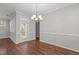 Bright dining room with hardwood floors, modern lighting and large glass door at 1172 Pemberly Ave, Morrisville, NC 27560
