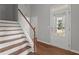 Inviting entryway with hardwood floors, staircase, and bright front door at 1172 Pemberly Ave, Morrisville, NC 27560