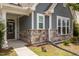 Close up of a home's exterior with beautiful stone accents and a covered porch at 1172 Pemberly Ave, Morrisville, NC 27560