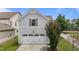 Two car garage featuring modern, durable white doors with a clean driveway and well-maintained yard at 1172 Pemberly Ave, Morrisville, NC 27560