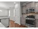 Stylish kitchen featuring granite countertops, stainless steel appliances, and gray cabinets at 1172 Pemberly Ave, Morrisville, NC 27560
