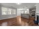 Open concept living space with hardwood floors, fireplace, and modern kitchen with stainless appliances at 1172 Pemberly Ave, Morrisville, NC 27560