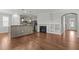 Living room and kitchen feature hardwood floors, a fireplace, and stainless steel appliances at 1172 Pemberly Ave, Morrisville, NC 27560