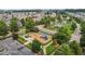 Aerial view of a community playground with mature trees, covered benches, and safety fencing at 1172 Pemberly Ave, Morrisville, NC 27560